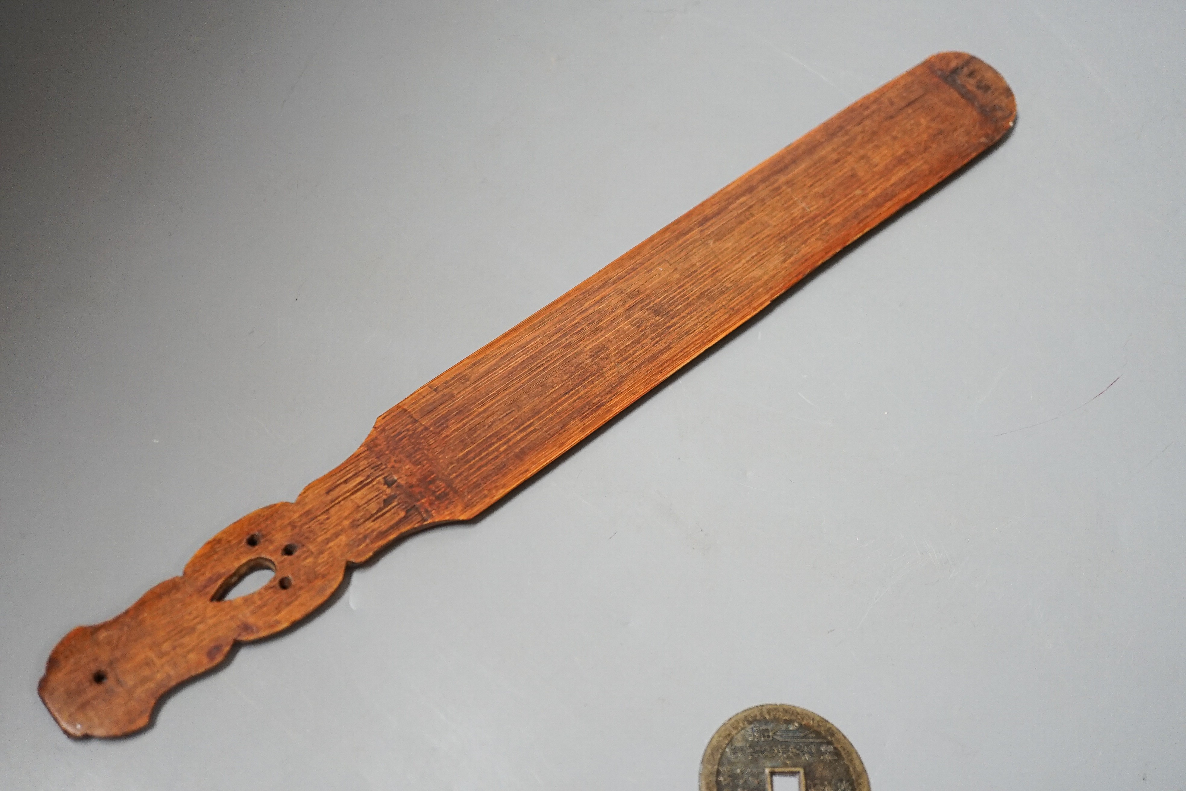 A Chinese soapstone snuff bottle, another snuff bottle, a bamboo page turner, 40cm and a brass amulet